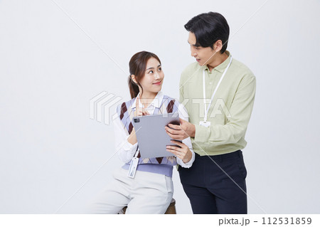 A man and woman smiling at a tablets 112531859
