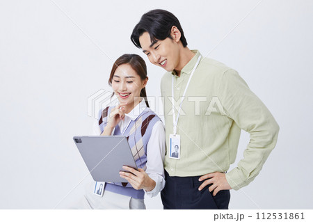 A man and woman smiling at a tablets 112531861