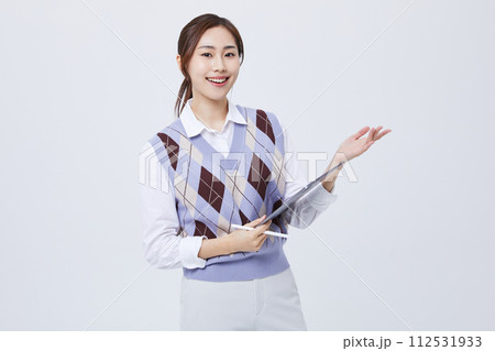 A photo of an office worker holding a tablet with his employee ID around his neck 112531933