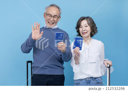 A senior greeting with a passport A senior greeting with a passport 112532206