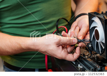 Close up of man repairing computer system unit 112532363