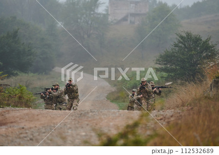 A disciplined and specialized military unit, donned in camouflage, strategically patrolling and maintaining control in a high-stakes environment, showcasing their precision, unity, and readiness for 112532689
