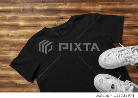 Cotton T-shirt mock up on wooden background flat lay Cotton T-shirt mock up on wooden background flat lay 112532971