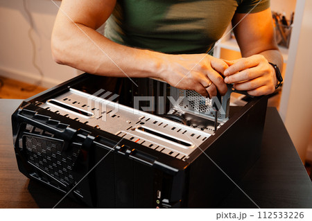 Close up of man repairing computer system unit 112533226