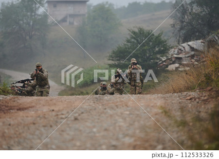 A disciplined and specialized military unit, donned in camouflage, strategically patrolling and maintaining control in a high-stakes environment, showcasing their precision, unity, and readiness for 112533326