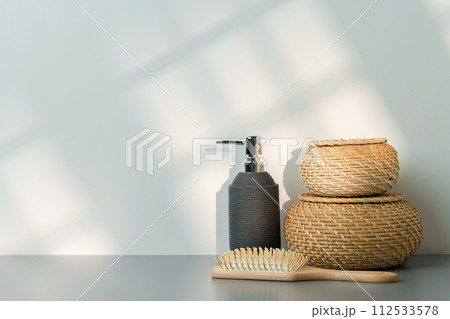 Soap dispenser and hair brush on gray background Soap dispenser and hair brush on gray background 112533578