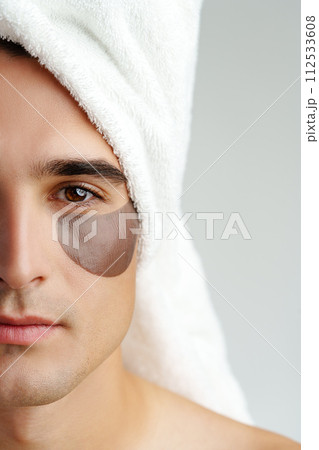 Portrait of attractive young male model with eye patches on white background 112533608