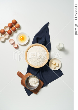 Flour, butter, and eggs are served on a plate Flour, butter, and eggs are served on a plate 112533614