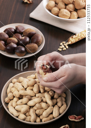 peel peanuts with both hands peel peanuts with both hands 112533735