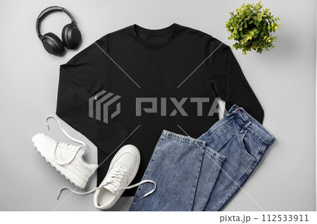 T-shirt, jeans and white sneakers on gray background top view 112533911