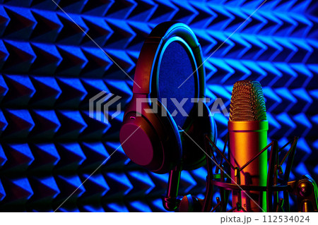 Professional microphone in a recording studio in blue light Professional microphone in a recording studio in blue light 112534024