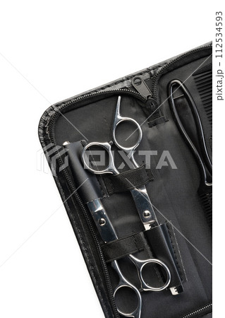 Hairdressing scissors with leather case on white background Hairdressing scissors with leather case on white background 112534593