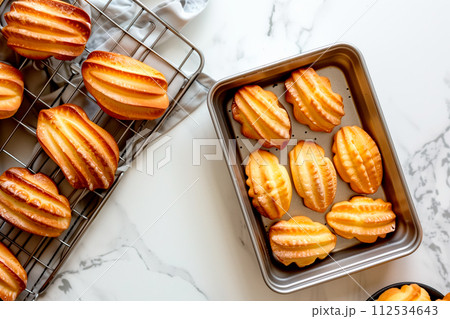 Classic French madeleine cookies, buttery and delicate, mini sponge cake baked in scallop mold Classic French madeleine cookies, buttery and delicate, mini sponge cake baked in scallop mold 112534643