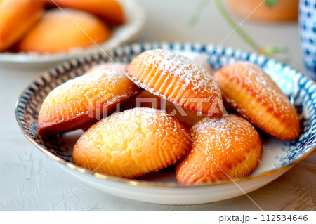 Classic French madeleine cookies, buttery and delicate, mini sponge cake baked in scallop mold Classic French madeleine cookies, buttery and delicate, mini sponge cake baked in scallop mold 112534646