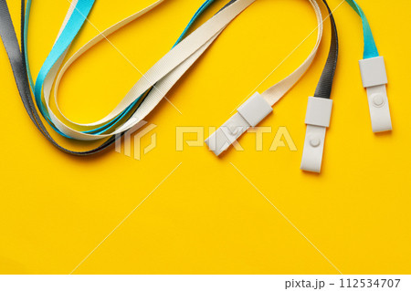 Badge strings on yellow background close up Badge strings on yellow background close up 112534707