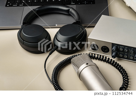 Headphones and microphone on the table close up 112534744