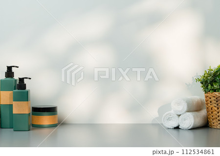 Soap dispenser and spa towels on white background in shadow Soap dispenser and spa towels on white background in shadow 112534861
