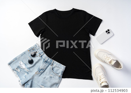 T-shirt, jeans and white sneakers on gray background top view T-shirt, jeans and white sneakers on gray background top view 112534903