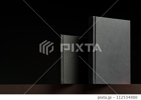 Black hardcover book or notepad mock up on black background 112534980