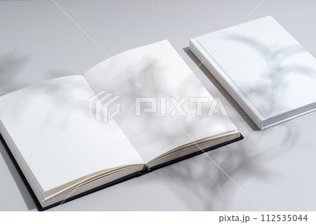 Blank open notepad on gray background studio shot 112535044