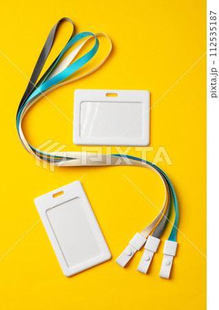 Blank badge with string on yellow background 112535187