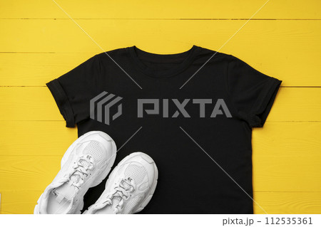 Cotton T-shirt mock up on wooden background flat lay Cotton T-shirt mock up on wooden background flat lay 112535361