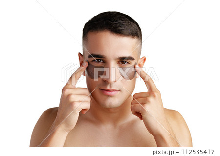 Portrait of attractive young male model with eye patches on white background 112535417