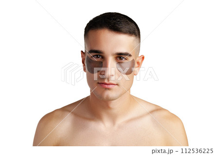 Portrait of attractive young male model with eye patches on white background 112536225