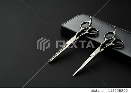 Hairdressing scissors with case on a black background Hairdressing scissors with case on a black background 112536266