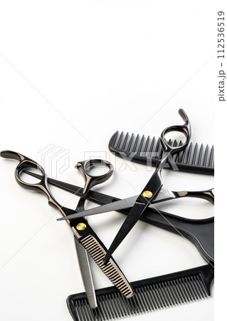 Black hairdressing tools and various hairbrushes on white background Black hairdressing tools and various hairbrushes on white background 112536519