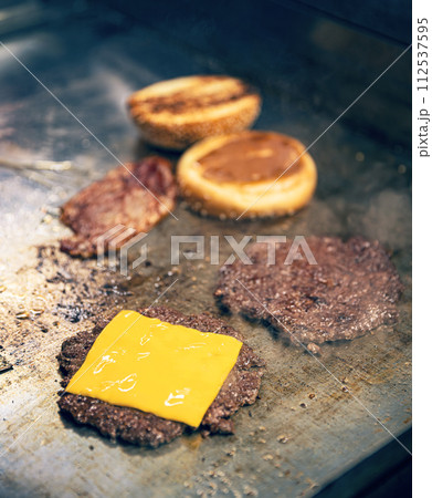 Cooking burgers on hot grill 112537595