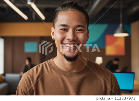 AI-generated content. Casual man in a brown shirt smiling with a tablet. Innovative workspace and teamwork in the background. 112537973