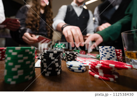 A team of young boys and girls play poker. First-person observation of card poker from various close-up angles. A team of young boys and girls play poker. First-person observation of card poker from various close-up angles. 112538430