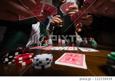 A team of young boys and girls play poker. First-person observation of card poker from various close-up angles. A team of young boys and girls play poker. First-person observation of card poker from various close-up angles. 112538434