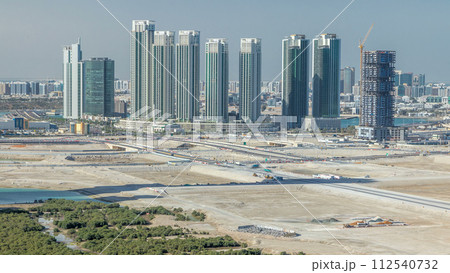 Buildings on Al Reem island in Abu Dhabi timelapse from above. 112540732