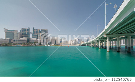 Modern buildings in Abu Dhabi skyline timelapse hyperlapse with mall and beach. 112540769