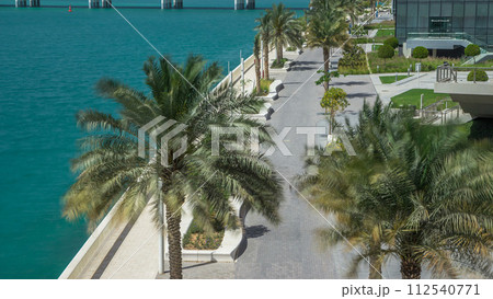 Walkway in Abu Dhabi timelapse with palms 112540771