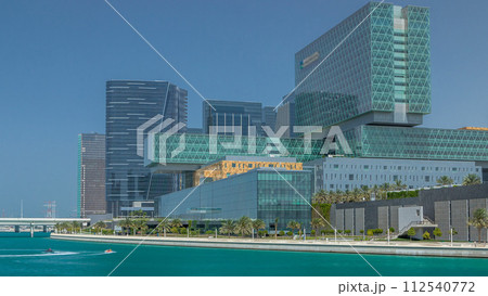 Modern buildings in Abu Dhabi skyline timelapse with mall and beach. 112540772