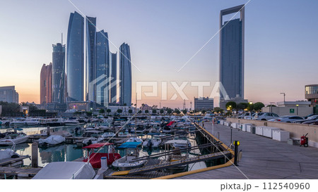 Al Bateen marina Abu Dhabi day to night timelapse with modern skyscrapers on background 112540960