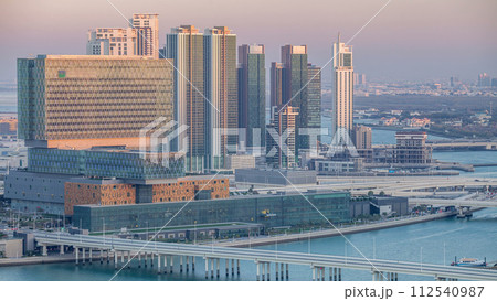 Aerial skyline of Abu Dhabi city centre from above day to night timelapse 112540987