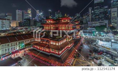 The Buddha Tooth Relic Temple comes alive at night timelapse in Singapore Chinatown, with the city skyline in the background. The Buddha Tooth Relic Temple comes alive at night timelapse in Singapore Chinatown, with the city skyline in the background. 112541174