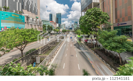 Traffic with cars on a street and urban scene in the central district of Singapore timelapse Traffic with cars on a street and urban scene in the central district of Singapore timelapse 112541181