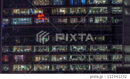 Modern office building with big windows at night timelapse, in windows light shines Modern office building with big windows at night timelapse, in windows light shines 112541232