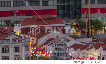 Old houses in Chinatown with Details of the decorations on the roof of the Sri Mariamman Hindu temple aerial day to night timelapse, Singapore 112541236