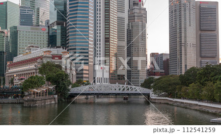 Singapore skyscrapers skyline with white Anderson Bridge near esplanade park day to night timelapse. 112541259