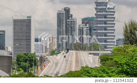Traffic with cars on a street and urban scene in the central district of Singapore timelapse 112541322