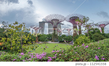 Futuristic aerial view of amazing illumination at Garden by the Bay day to night timelapse in Singapore. 112541338