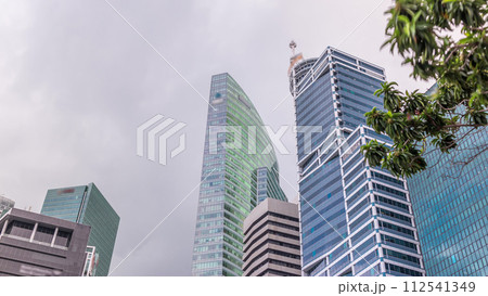 Looking up perspective of modern business skyscrapers glass and sky view landscape of commercial building in central city timelapse Looking up perspective of modern business skyscrapers glass and sky view landscape of commercial building in central city timelapse 112541349