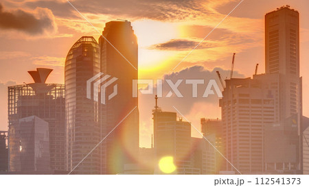 Sunset over the downtown skyline of Singapore as viewed from across the water from The Garden East timelapse. Singapore. 112541373