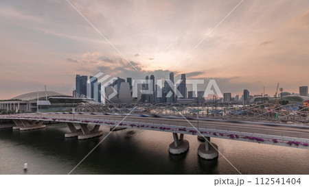 Aerial view of sunset over Helix Bridge and Bayfront Avenue with traffic timelapse at Marina Bay, Singapore Aerial view of sunset over Helix Bridge and Bayfront Avenue with traffic timelapse at Marina Bay, Singapore 112541404